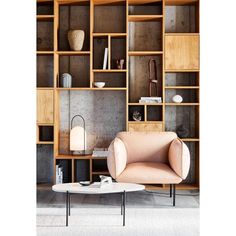 a living room filled with lots of wooden bookshelves next to a coffee table