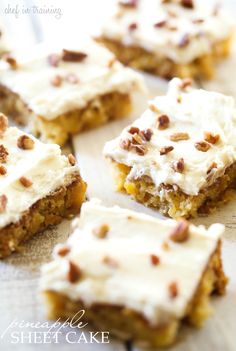 several pieces of cake with white frosting and nuts