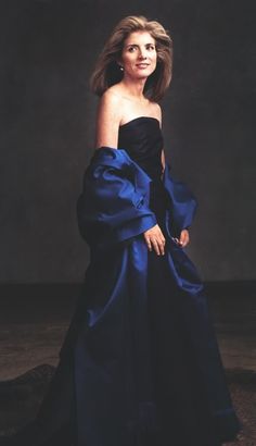 a woman in a blue dress posing for a photo