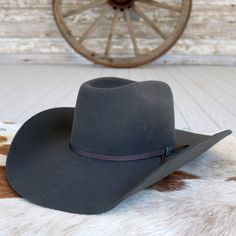 Introducing the Cody Johnson 9th Round Granite Grey cowboy hat, a tribute to classic Western style with a modern twist. Handcrafted in Texas, USA, from premium 3X wool, it boasts a commanding 4 5/8" bull rider crown and a sleek 4 1/4" brim for a bold silhouette. Complete with a stylish 2-Ply hatband adorned with a hat pin. Whether you're hitting the rodeo or the honky-tonk, this hat embodies the spirit of the American frontier with unmatched quality and flair.     4 1/4" Brim  4 5/8" Bullrider C Grey Cowboy Hat, Cody Johnson, Beaded Hat Bands, Bull Rider, American Frontier, Felt Cowboy Hats, Kids Belt, Looks Country, Beaded Hat