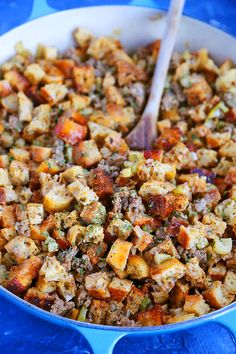 a blue bowl filled with stuffing and vegetables