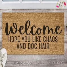 a welcome mat with the words,'welcome hope you like chaos and dog hair '