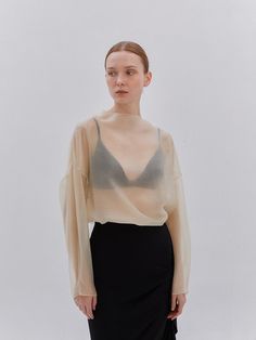 Softly structured, this effortless blouse.It is exceptionally soft and durable.Great outfits start here. - Collarless boat neck blouse- Lightweight fabric with a luxe look and feel- Slightly oversized fit, so it fits loosely and easily - Different hem and back zip closure - It's glossed and silky Luxury Sheer Tops For Summer, Luxury Sheer Top For Fall, Luxury Sheer Top For Summer, Luxury Sheer Blouse For Daywear, Luxury Classic Tops With Sheer Sleeves, Luxury Fitted Blouse With Sheer Bodice, Luxury Sheer Silk Blouse, Luxury Blouse With Sheer Sleeves, Luxury Sheer Tops For Daywear