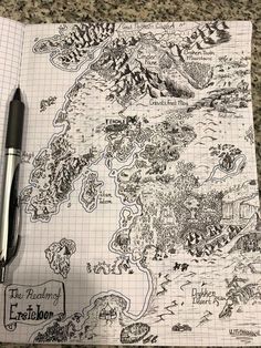 a notebook with a map drawn on it and a pen resting on the page next to it