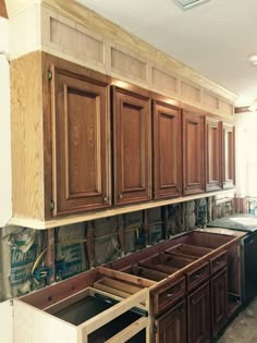 a kitchen with wooden cabinets and drawers in the process of remodeling it