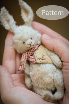 a hand holding a small stuffed rabbit in it's right hand with the words pattern above it