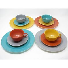 six different colored plates with cups and saucers