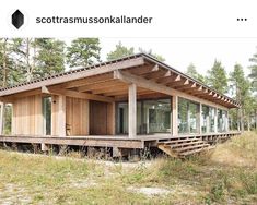 a small wooden cabin sitting on top of a lush green field