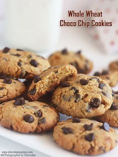 chocolate chip cookies on a plate next to a glass of milk with the words, whole wheat choco chip cookies