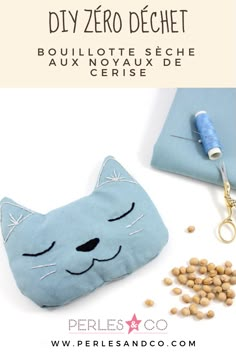 a blue cat pouch with eyes closed next to some dry food and a pen holder