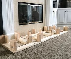 there are many pieces of wood on the floor in front of a wall with windows