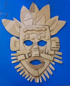 a mask made out of wood on a blue background with words written in the middle