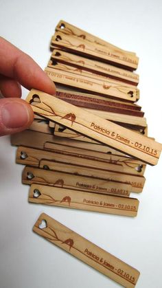 a person is holding some wooden tags in their hand