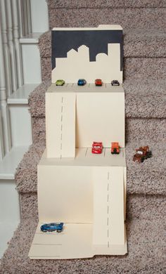 toy cars are lined up on the stairs