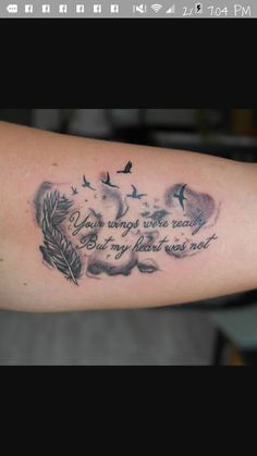 a person with a tattoo on their arm that says your wings were ready but my heart went out