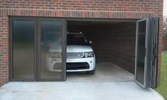 a car is parked in the garage with its door open to let people know what they are looking for