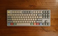 a computer keyboard sitting on top of a wooden floor next to a mouse and pad