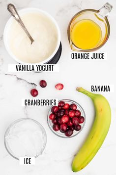 ingredients to make cranberry orange smoothie on a white marble counter top with text overlay