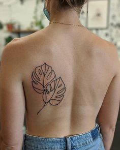 a woman with a tattoo on her back