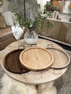 a table with three trays sitting on top of it in front of a couch