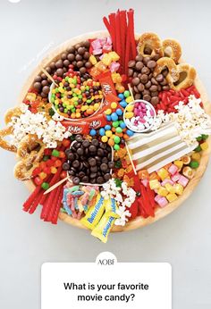 a bowl filled with lots of candy and candies on top of a white table