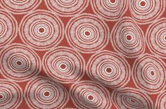 a red and white fabric with circles on it