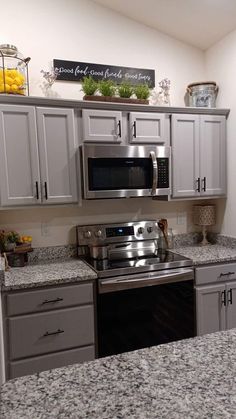 a kitchen with granite counter tops and stainless steel appliances on the wall above the stove