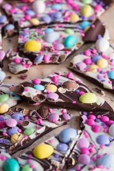 there are many pieces of chocolate with easter eggs on it and sprinkles