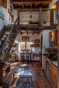 an open floor plan with stairs leading up to the kitchen and dining room in this rustic style home