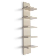 a white wall shelf with three shelves on each side and one in the other corner