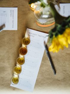 a table topped with bottles of wine and paper