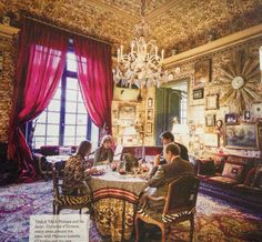 people sitting around a table in a fancy room