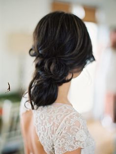 the back of a woman's head wearing a wedding dress