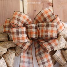 an orange and brown plaid bow on a door