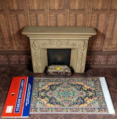 a carpet and rug in front of a fireplace