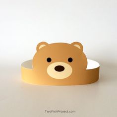 a brown teddy bear head on top of a white paper tape with the word fish project written below it