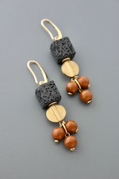 Gold plated brass hooks with lava and glass beads. Each earring weighs .275 oz. and measures 2.625 inches long. Elegant Adjustable Lava Stone Jewelry, Brown Brass Jewelry With Dangling Beads, Dangle Earrings With Natural Stones And Czech Glass, Bronze Drop Earrings With Dangling Beads, Bronze Dangle Earrings With Natural Stones, Lava Jewelry, Brass Hooks, Brass Hook, Beaded Earrings Patterns