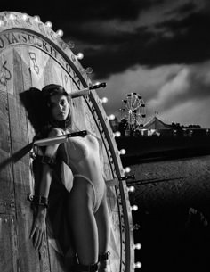 a woman standing in front of a giant clock