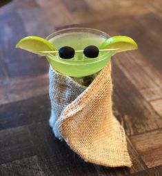 the yoda star wars drink is in a mason jar with two olives sticking out of it