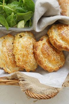 breads and salad in a basket on a table