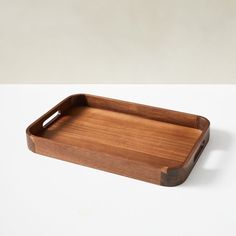 a wooden tray sitting on top of a white table