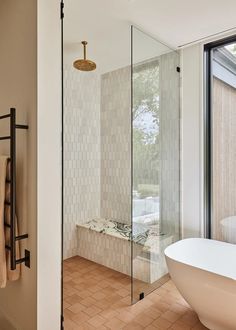 a bath tub sitting next to a walk in shower