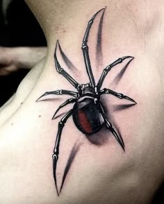 a spider tattoo on the back of a woman's upper body, with large claws