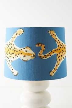 a lamp shade with two cheetah on it