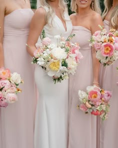 the bride and her bridesmaids are holding their bouquets