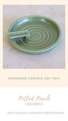 a green plate with a fork in it and the words, handmade ceramic ash tray