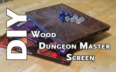 a wooden game board with dices sitting on top of it and the words, wood dungeon master screen