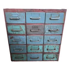 an old blue metal filing cabinet with lots of drawers