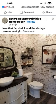 the bathroom is decorated in white and black with pictures on the brick wall behind it