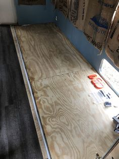 the inside of a trailer with plywood being laid out on the floor and ready to be installed